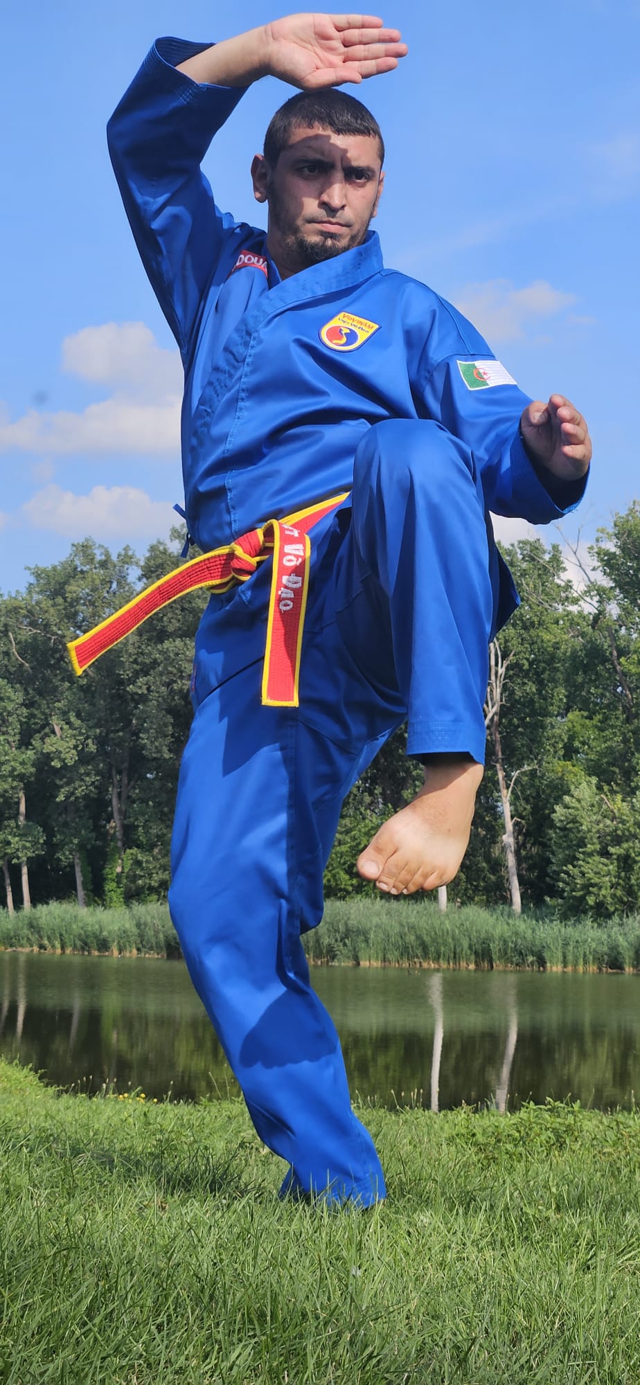 A high side kick extended against the sky