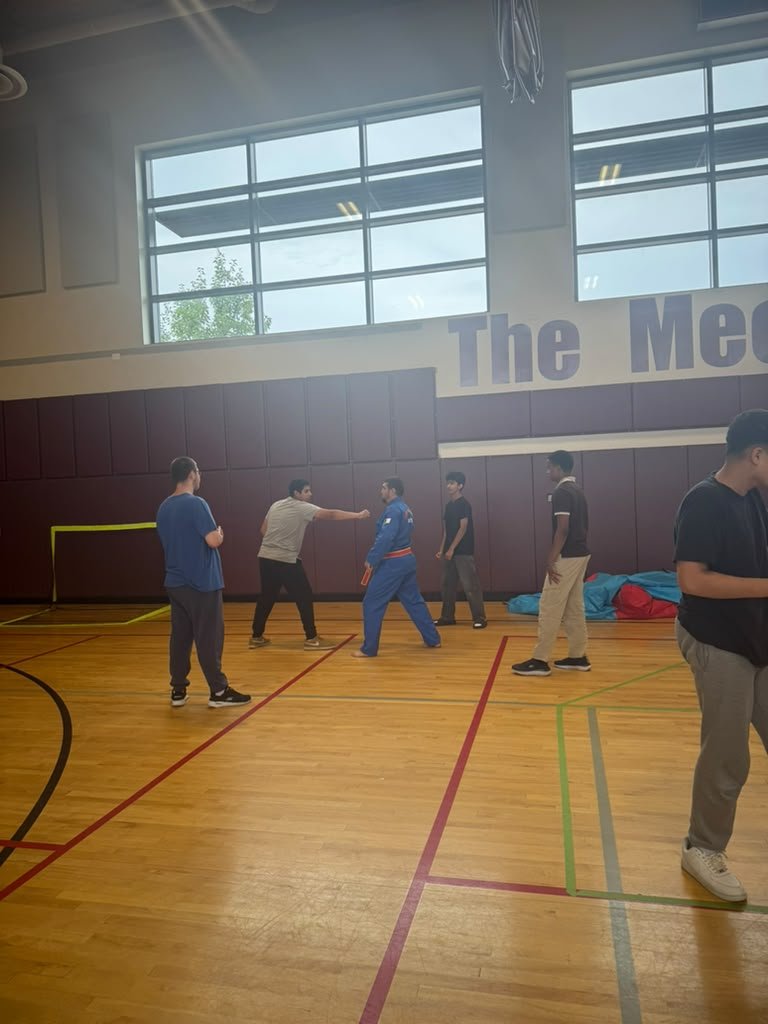 Coaching the group through drills at The Mecca Center gym