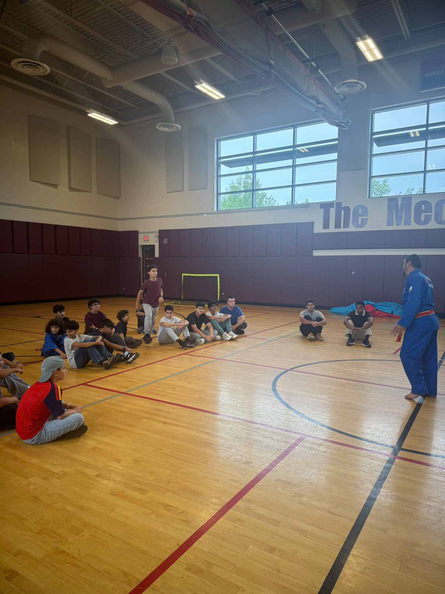Kids listening to Coach Redouane during the Mecca Center Vovinam session