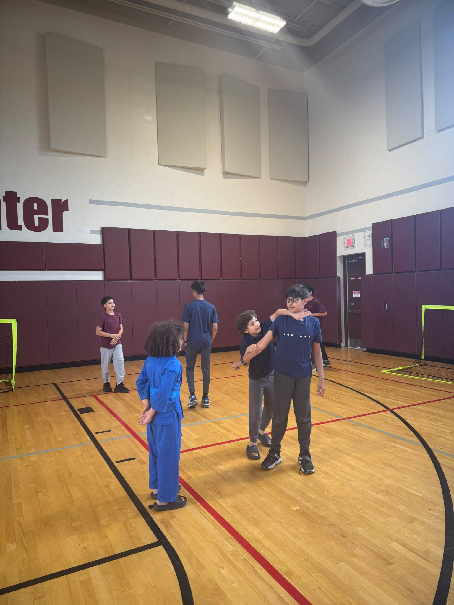 Students practicing partner drills at Mecca Center