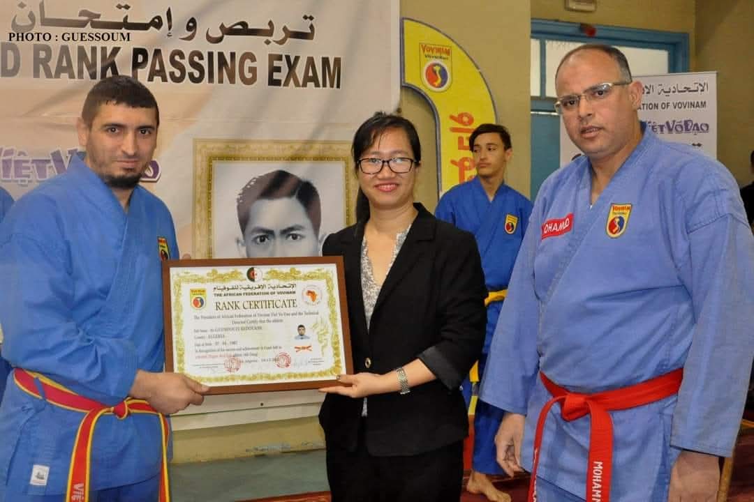 Redouane receiving his framed FAVV Rank Certificate from a WVVF official