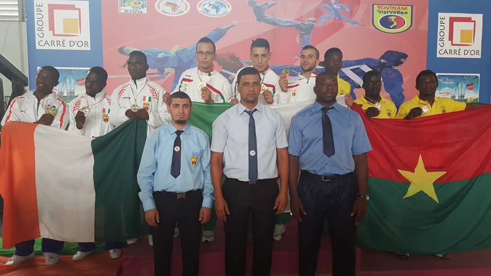 Redouane among the officiating referees at a continental championship podium in Côte d'Ivoire