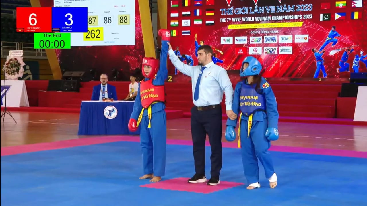 Redouane officiating, raising the winner's hand at the 2023 WVVF World Championship in Vietnam