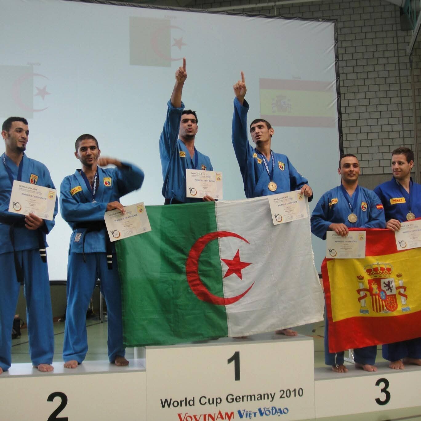 World Cup 2010 Germany — Algeria team atop the number-one podium, pointing to the sky